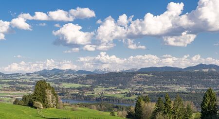 View to villages surrounded by forests, water and mountains. Bavaria.の写真素材