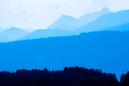 Spectacular view of mountain ranges silhouettes in blue twilight hourの写真素材