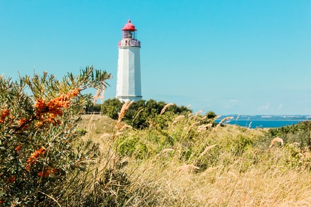 Old lighthouse Dornbusch on sunny summer day. Hiddensee, Baltic Sea.の写真素材