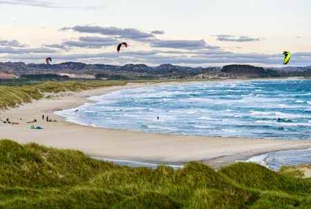 Kitesurfing men in action on stormy sunset evening at Brusand Beach, Norway.の写真素材
