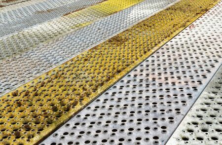 Metallic background of colored hole perforation plates.の写真素材