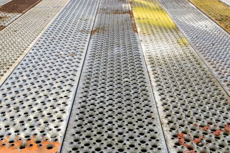 Metallic background of colored hole perforation plates.の写真素材