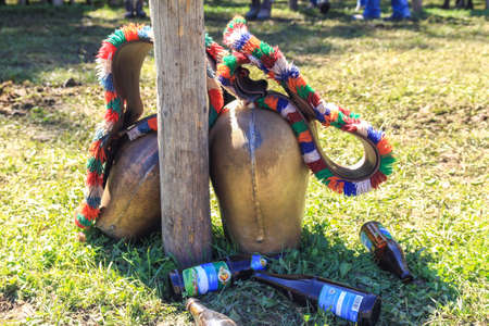 BAD HINDELANG, BAVARIA, GERMANY - SEPTEMBER 10 2011: Huge colorful cowbell and empty beer bootles on the ground at the traditional annual Almabtrieb, Viehscheid in Allgaeu, Bavarian Alps.のeditorial素材