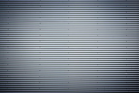 Corrugated metal sheet. New and Modern silver grey background pattern with nice vignetting.の写真素材