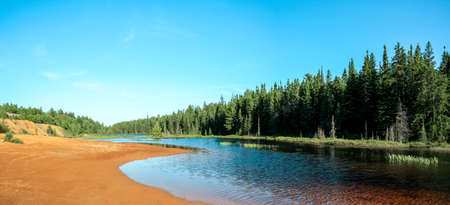 Idyllic Blue lake and forest landscape in evening sunset sunlight. Foy, Foyross Lake, Sudbury, Ontario, Canada.の写真素材