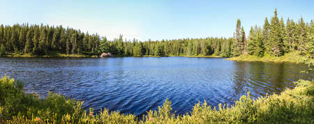 Idyllic Blue lake and forest landscape in evening sunset sunlight. Sudbury, Ontario, Canada.の写真素材