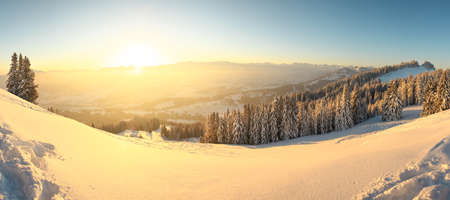 Beautiful Sunrise in snow mountains landscape. Amazing yellow Sunshine. Allgau, Mittag Mountain, Bavaria, Alps, Germany.の写真素材