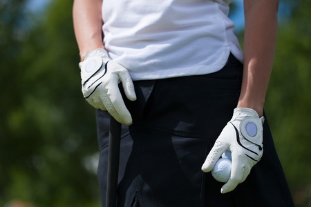 Golf player white gloves hold the iron or putter in right poseの写真素材