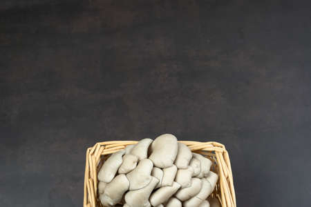 Mushrooms in a wooden basket. Brown background.の写真素材