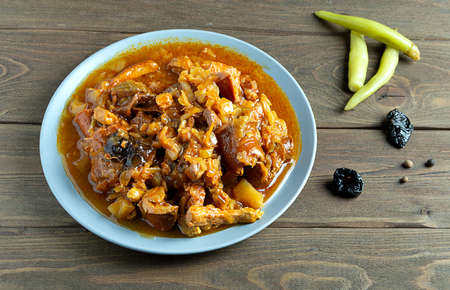 Polish dish bigos made from cabbage, meat and sausages. In a gray plate, on a dark wooden background.の写真素材