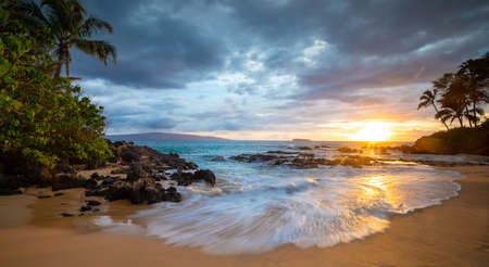 Beach cove at sunset on Maui, Hawaiiの写真素材