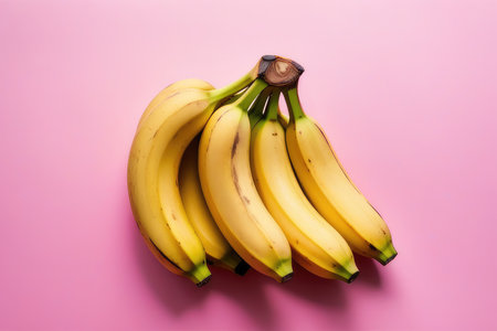 Bunch of bananas on pink background. Top view, flat layの素材