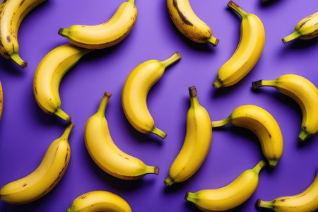 Bananas pattern on purple background. Flat lay, top view.の素材