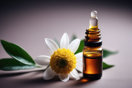 Essential oil in a small glass bottle and camomile flowerの素材