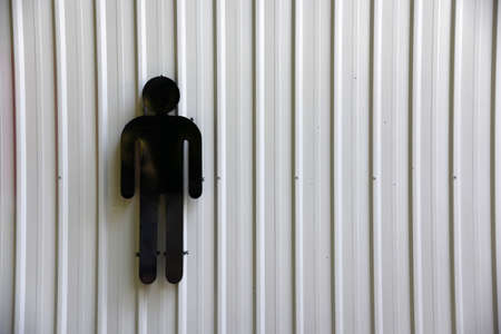 Men of sign in toilet on the white metal sheet background .の写真素材