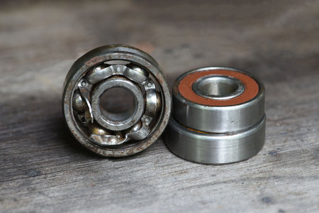 old rusty and damaged ball bearing on wood table .の写真素材