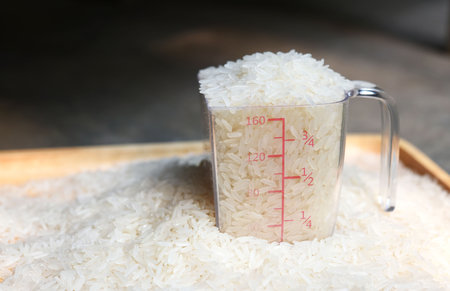 organic rice in a measure cup .の写真素材