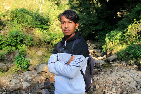 A boy is carrying bag and taking photo at Nepal as fashion model , new winter fashion clothe and...