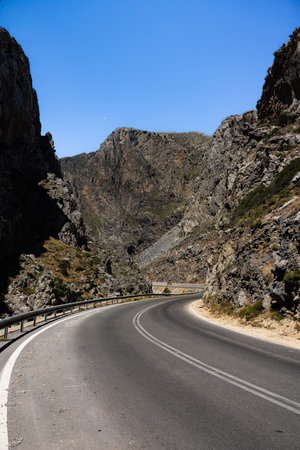 Let the rugged beauty of Crete surround you as you navigate this enchanting canyon road. Towering cliffs stand as sentinels, guiding your journey through the heart of nature's masterpiece. The winding road offers a captivating experience, unveiling the untamed splendor of this remarkable landscape at every turnの写真素材