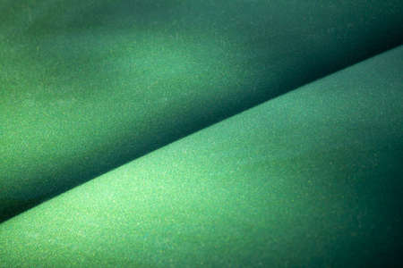 Green metallic shiny surface with a diagonal lineの写真素材