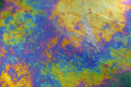 Iridescent surface of a metallic plate (background)の写真素材