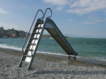 Tobboggan slide on the lake Leman pebble beach (Geneva, Switzerland)の写真素材