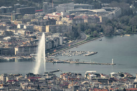Aerial view of Geneva (Switzerland) with its famous water spring, city center, docks and ngos taken...
