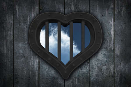 heart prison window on wooden planks background - 3d illustrationの写真素材