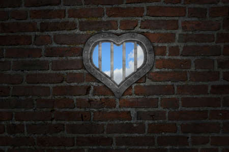 heart prison window in old brick wall - 3d illustrationの写真素材