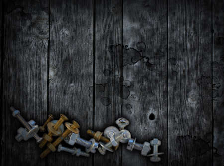  screws and nuts on old wooden backgroundの写真素材