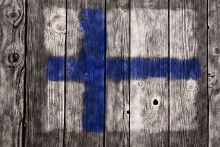 finnish flag on aged wooden woundの写真素材