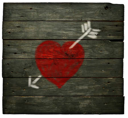 painted heart with arrow on old wooden planksの写真素材