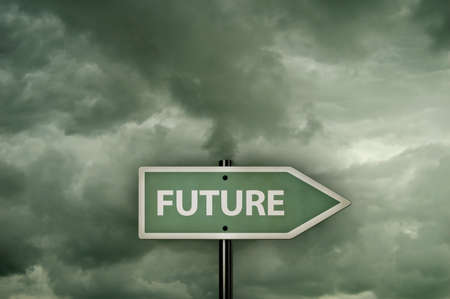 the word future on signpost under dark cloudsの写真素材