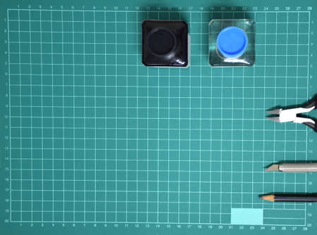 Top view Plastic model tool kit ink, art knife, cutting pliers on Cutting plate and copy spaceの写真素材