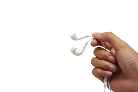 male hand holding a one of damage earphone with isolated background and copy spaceの写真素材