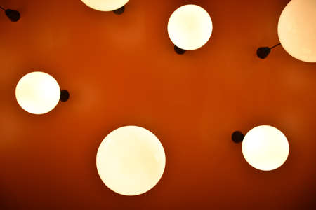 low angle circle lamp with orange backgroundの写真素材