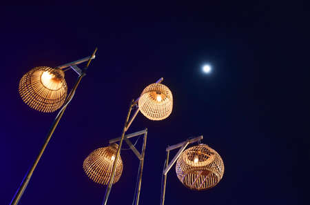 four Thai ancient lamp and blue light with night sky and full moon background