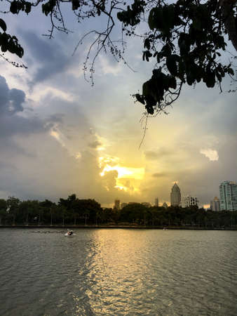 sunrise in the city park with duck boat on a pond