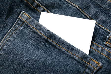 blank white paper or card in back pocket of blue jeans with copyspace for sale text or business conceptの写真素材