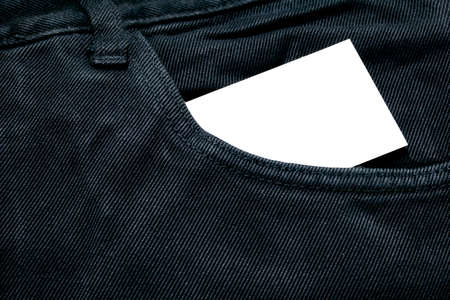 blank white paper or card in front pocket of black jeans with copyspace for sale text or business conceptの写真素材