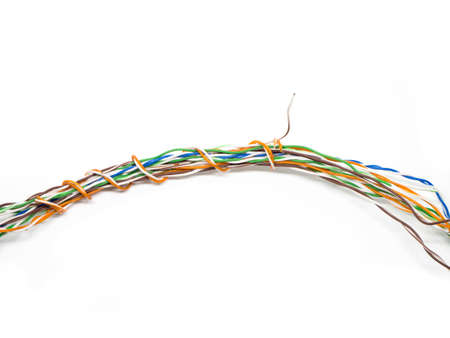 mess colorful electric wire on isolated white backgroundの写真素材