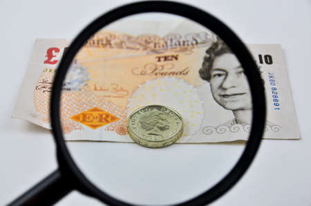 British banknotes and coin view by magnifierの写真素材