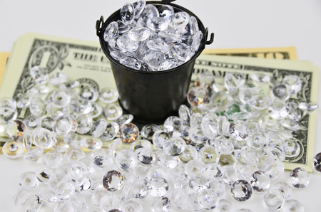 US Dollars covered with diamonds and bucketの写真素材