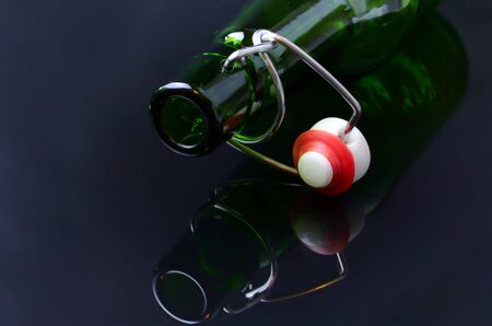 Empty beer bottles  lie on black glassの写真素材