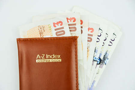 Address book with british pounds insideの写真素材