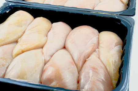 Raw chicken breast 5 kg in plastic containerの写真素材