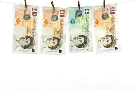 Dirty money hanging from a clothesline isolated on white.の写真素材