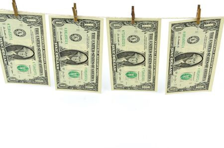 Dirty money hanging from a clothesline isolated on white.