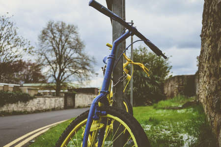 Old retro bike painted with yellow color. Vintage effect.の写真素材