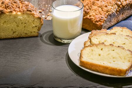 Yeast cake with crumble and glass of milk.
